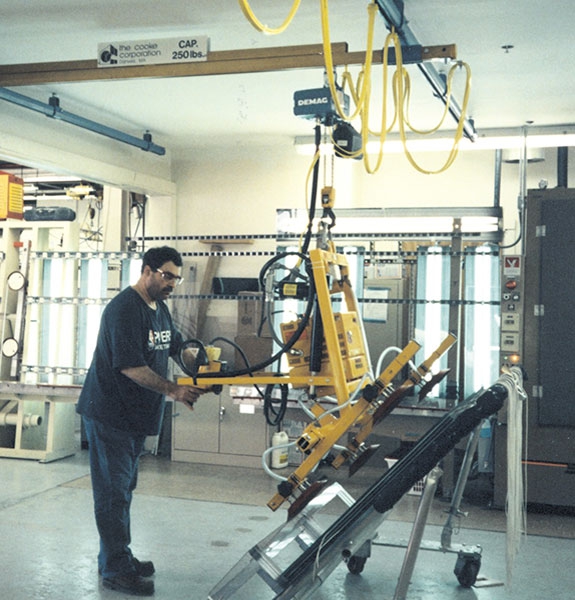 Vacuum lifter with electric powered tilt